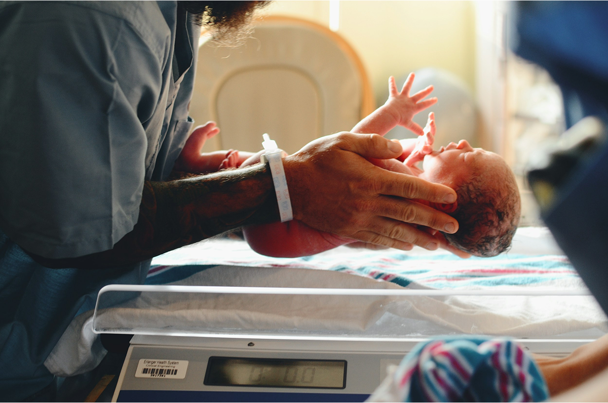 Newborn baby being weighed during a health checkup