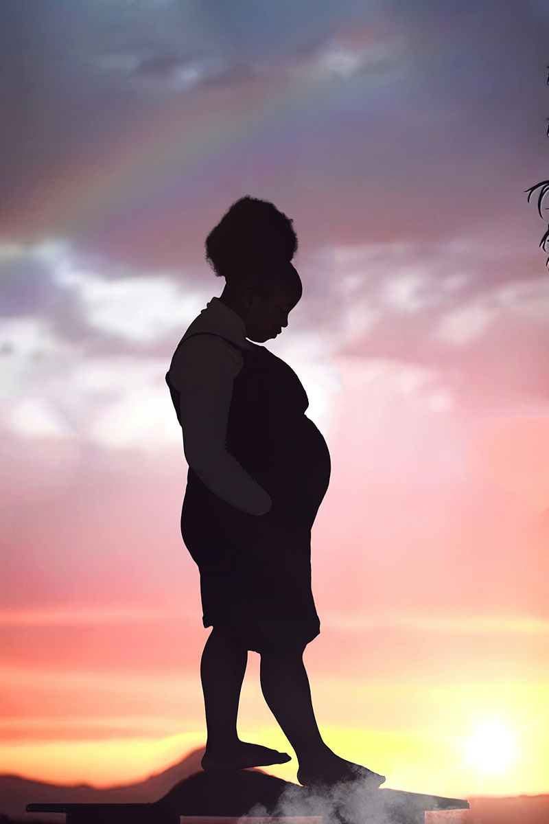 Silhouette of a pregnant woman against a beautiful sunset sky